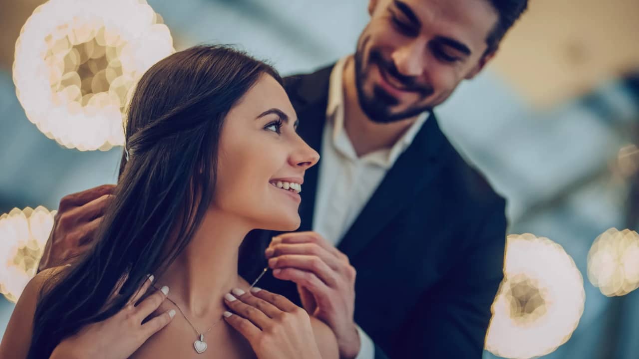 un homme offre un bijoux à sa copine ou femme pour la Saint-Valentin